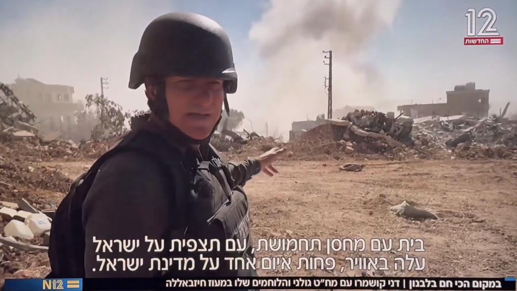 Channel 12 journalist Danny Kushmaro pointing to the area where he detonated a house in the Lebanese village of Ayta Al-Sha’b. (Photo: Screenshot)